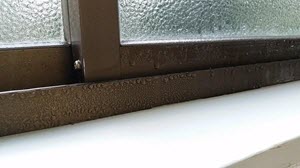 closeup on interior window frame with condensation