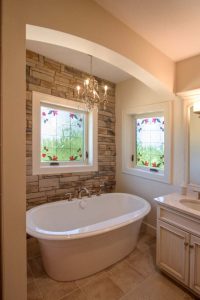 Interior of bathroom with ProVia art glass windows above tub and sink