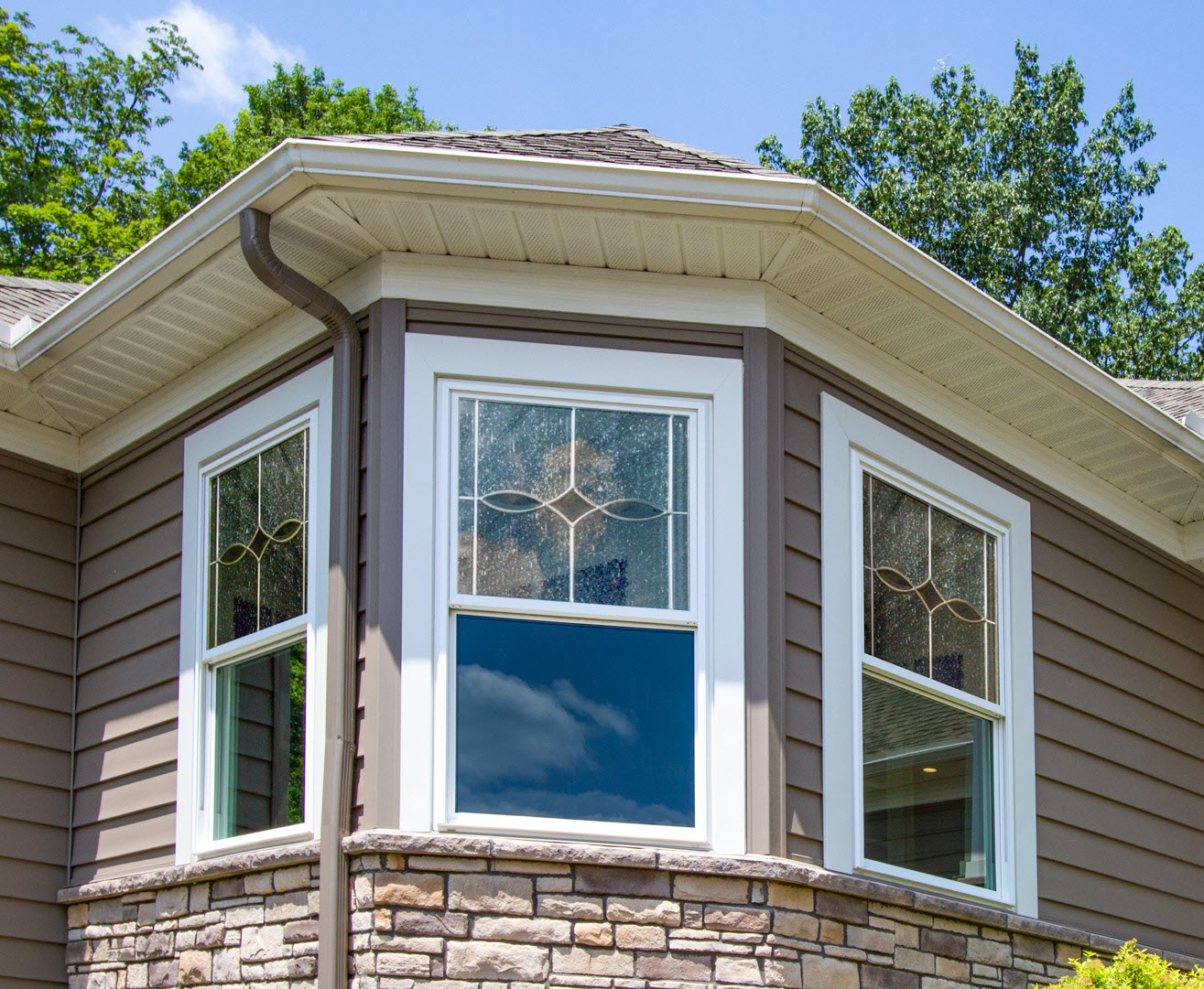 Wood-clad vinyl double-hung windows on a historic Minnesota home, blending traditional style with modern energy efficiency.